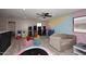 Spacious game room with hardwood floors, ceiling fan, comfortable couch and vintage arcade games at 537 S 153Rd Ln, Goodyear, AZ 85338