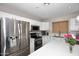 Modern kitchen features white cabinets, stainless steel appliances, and quartz countertops at 537 S 153Rd Ln, Goodyear, AZ 85338