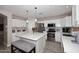 Modern kitchen features white cabinets, stainless steel appliances, and quartz countertops at 537 S 153Rd Ln, Goodyear, AZ 85338
