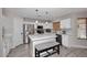 Bright, eat-in kitchen with stainless steel appliances, white cabinetry, and a center island at 537 S 153Rd Ln, Goodyear, AZ 85338