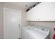 Functional laundry room with washer, dryer, and ample storage cabinets at 537 S 153Rd Ln, Goodyear, AZ 85338
