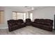 Spacious living room is furnished with reclining sofa set, carpet flooring, and a ceiling fan at 537 S 153Rd Ln, Goodyear, AZ 85338