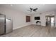 Bright living room with laminate floors, ceiling fan, and recessed lights is move-in ready at 537 S 153Rd Ln, Goodyear, AZ 85338