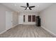 Bright living room featuring light wood floors, a ceiling fan and natural light at 537 S 153Rd Ln, Goodyear, AZ 85338