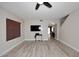 An airy living room boasting modern flooring, a sleek TV setup, and a view into the dining area at 537 S 153Rd Ln, Goodyear, AZ 85338