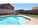 Sparkling blue pool with a table for outdoor eating and a beautiful clear blue sky at 537 S 153Rd Ln, Goodyear, AZ 85338