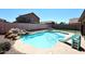 Backyard pool with a slide, rock waterfall and picnic table at 537 S 153Rd Ln, Goodyear, AZ 85338