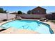 Private backyard pool featuring a rock waterfall and slide at 537 S 153Rd Ln, Goodyear, AZ 85338
