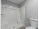 This bathroom has a white shower, gray wall paint and white tile flooring at 5436 E Aspen E Ave, Mesa, AZ 85206
