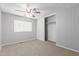 Cozy bedroom with neutral carpet, a ceiling fan, and a closet at 5436 E Aspen E Ave, Mesa, AZ 85206