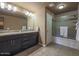 Bathroom features a dual sink vanity, shower/tub combo, and neutral tile floors at 5450 E Deer Valley Dr # 2191, Phoenix, AZ 85054