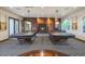 Cozy billiard room features two pool tables and a fireplace with pool accessory storage at 5450 E Deer Valley Dr # 2191, Phoenix, AZ 85054