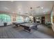 Elegant billiards room with two pool tables, arch windows, and comfortable seating for players at 5450 E Deer Valley Dr # 2191, Phoenix, AZ 85054