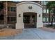Welcoming entrance to building 10 with an arched entryway and well-maintained landscaping at 5450 E Deer Valley Dr # 2191, Phoenix, AZ 85054