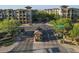 Community entrance featuring lush landscaping, signage, and access to residential buildings beyond at 5450 E Deer Valley Dr # 2191, Phoenix, AZ 85054
