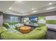 Comfortable lounge area with a plush green sectional sofa, a large TV, and stylish decor at 5450 E Deer Valley Dr # 2191, Phoenix, AZ 85054