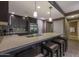 Kitchen with dark cabinets, stainless appliances, and a breakfast bar with pendant lighting at 5450 E Deer Valley Dr # 2191, Phoenix, AZ 85054