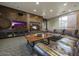 Cozy living room with a fireplace, large TV, and comfortable leather seating at 5450 E Deer Valley Dr # 2191, Phoenix, AZ 85054