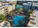 Aerial view of a resort-style pool area with palm trees and lounge chairs surrounded by multi-story buildings at 5450 E Deer Valley Dr # 2191, Phoenix, AZ 85054