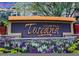 Community sign for Toscana of Desert Ridge surrounded by flowers and greenery at 5450 E Deer Valley Dr # 2191, Phoenix, AZ 85054