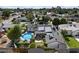Aerial view of a private backyard with a pool, fire pit, patio area, and solar panels on the roof at 5707 N 12Th Pl, Phoenix, AZ 85014