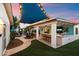 Outdoor living area with comfortable seating, a covered patio, and an outdoor kitchen, illuminated by string lights at 5707 N 12Th Pl, Phoenix, AZ 85014