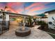 Paver patio features a fire pit, outdoor TV, and lush landscaping, perfect for entertaining and relaxation at 5707 N 12Th Pl, Phoenix, AZ 85014