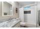Bathroom featuring marble vanity, framed mirror, and a shower-tub combo at 5707 N 12Th Pl, Phoenix, AZ 85014