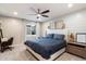 Bright bedroom features neutral decor, ceiling fan, and a large window overlooking the back yard at 5707 N 12Th Pl, Phoenix, AZ 85014