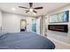 Modern bedroom with ceiling fan, accent wall, and a decorative fireplace for added warmth at 5707 N 12Th Pl, Phoenix, AZ 85014