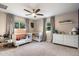 Cozy Bedroom with two white cribs, gray carpet, and ceiling fan with lots of natural light at 5707 N 12Th Pl, Phoenix, AZ 85014