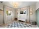 Sunlit bedroom with a playful checkered rug, built-in storage bench, and neutral decor at 5707 N 12Th Pl, Phoenix, AZ 85014