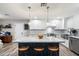 Modern kitchen with stainless steel appliances, marble countertops, and a center island with seating at 5707 N 12Th Pl, Phoenix, AZ 85014