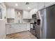 Bright kitchen with white cabinets, stainless steel appliances, and a decorative skull accent at 5707 N 12Th Pl, Phoenix, AZ 85014