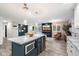 Open-concept living and kitchen area with a center island, modern decor, and wood-look flooring at 5707 N 12Th Pl, Phoenix, AZ 85014