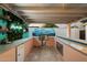 Outdoor kitchen and bar area, perfect for entertaining, with greenery and a lively vibe at 5707 N 12Th Pl, Phoenix, AZ 85014