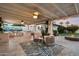Inviting covered patio with a fully equipped outdoor kitchen, fire pit and comfortable seating area at 5707 N 12Th Pl, Phoenix, AZ 85014