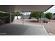Spacious backyard with covered patio, gravel, bushes, and stone walkway at 5720 E University Dr, Mesa, AZ 85205