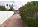 Backyard with a bush with pink flowers and a white fence at 5720 E University Dr, Mesa, AZ 85205