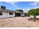 Large backyard with a covered patio and desert landscaping for easy maintenance at 5720 E University Dr, Mesa, AZ 85205