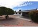 Charming backyard featuring a covered patio, mature trees, and easy-care landscaping at 5720 E University Dr, Mesa, AZ 85205