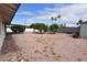 Expansive backyard with desert landscaping, mature trees, and a covered patio at 5720 E University Dr, Mesa, AZ 85205