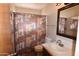 Neutral bathroom with tiled floors, patterned shower curtain, toilet, and vanity sink at 5720 E University Dr, Mesa, AZ 85205