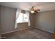 Bedroom featuring gray walls, carpet, and a window with natural light at 5720 E University Dr, Mesa, AZ 85205