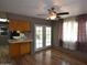 Open dining area with French doors, ceiling fan, vinyl flooring, and adjoining kitchen at 5720 E University Dr, Mesa, AZ 85205