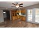 Open concept dining and kitchen area with tile countertops, ceiling fan and vinyl floor at 5720 E University Dr, Mesa, AZ 85205