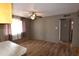 A dining room with light vinyl floors, a ceiling fan, and natural light from a window at 5720 E University Dr, Mesa, AZ 85205