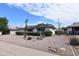 Frontal view of a single-story home displaying desert landscaping and a well-maintained yard at 5720 E University Dr, Mesa, AZ 85205