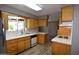 Well-lit kitchen featuring white countertops, wood cabinets, and modern appliances at 5720 E University Dr, Mesa, AZ 85205