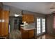 Spacious kitchen featuring laminate flooring, tile countertops, and ample cabinetry at 5720 E University Dr, Mesa, AZ 85205